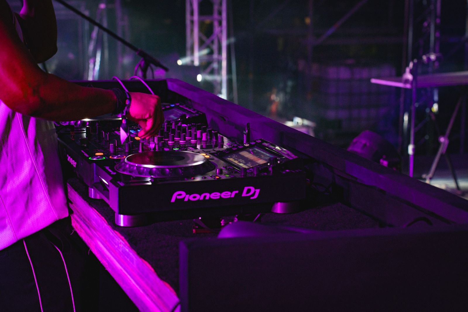 A production technician from Impact Production Group standing on the stage, overlooking the stadium seating before an event.
