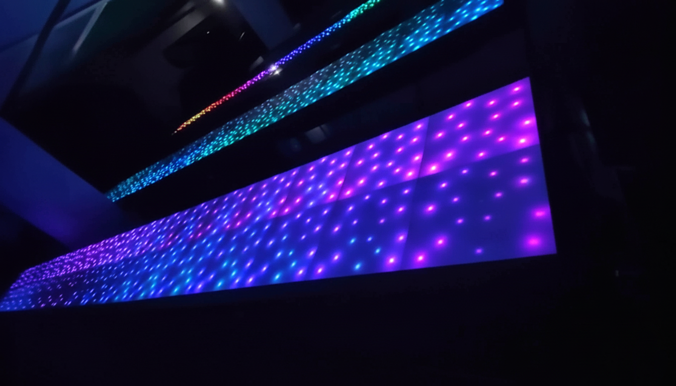 Vibrant RGB lights create a mesmerizing pattern on a building façade, transitioning through purple, blue, and red hues. The scene exudes a futuristic and dynamic ambiance.