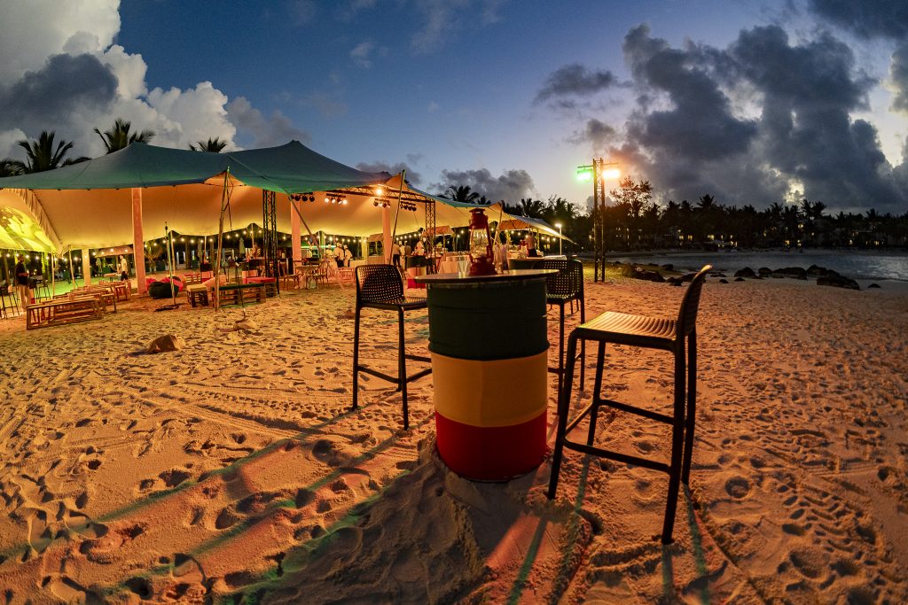 Reggae Night Mauritius beach event with colourful décor, drum cocktail tables, pallet photo booth and immersive event styling by Impact Production Group