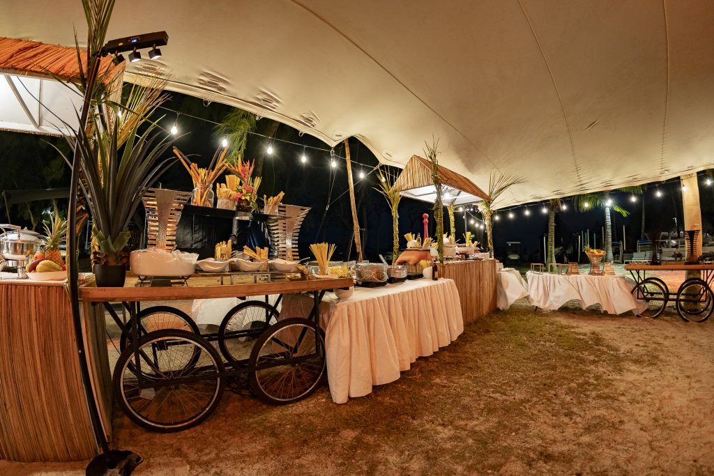 Reggae Night Mauritius beach event with colourful décor, drum cocktail tables, pallet photo booth and immersive event styling by Impact Production Group