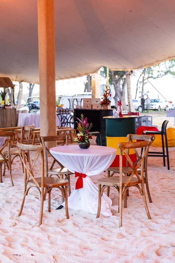 Reggae Night Mauritius beach event with colourful décor, drum cocktail tables, pallet photo booth and immersive event styling by Impact Production Group