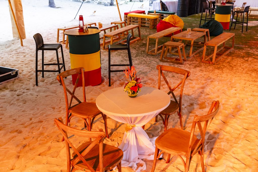Reggae Night Mauritius beach event with colourful décor, drum cocktail tables, pallet photo booth and immersive event styling by Impact Production Group