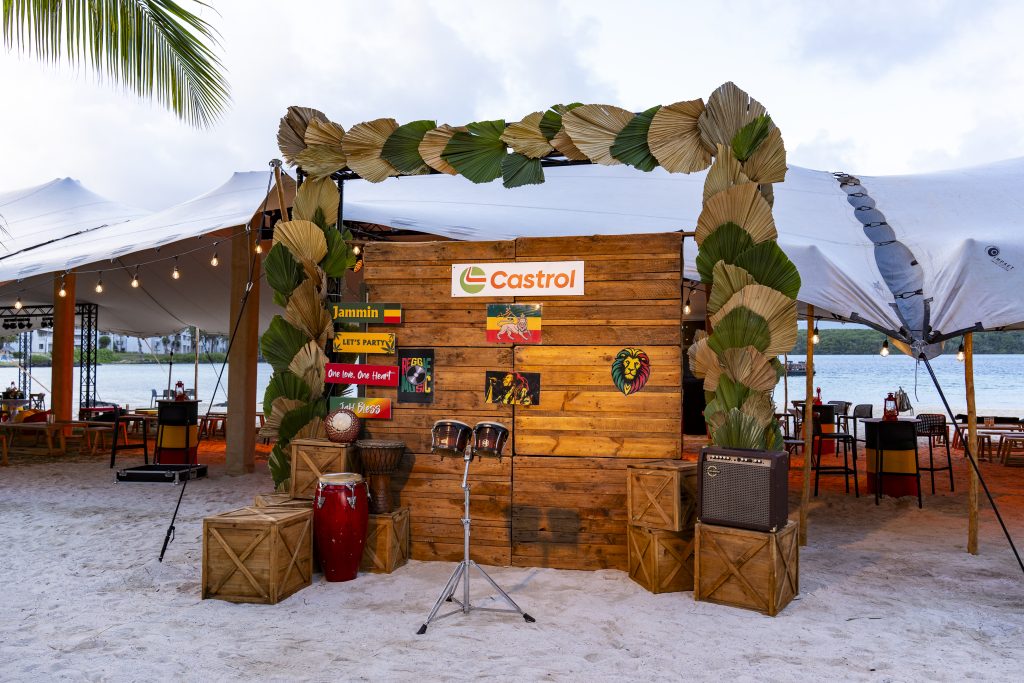 Reggae Night Mauritius beach event with colourful décor, drum cocktail tables, pallet photo booth and immersive event styling by Impact Production Group