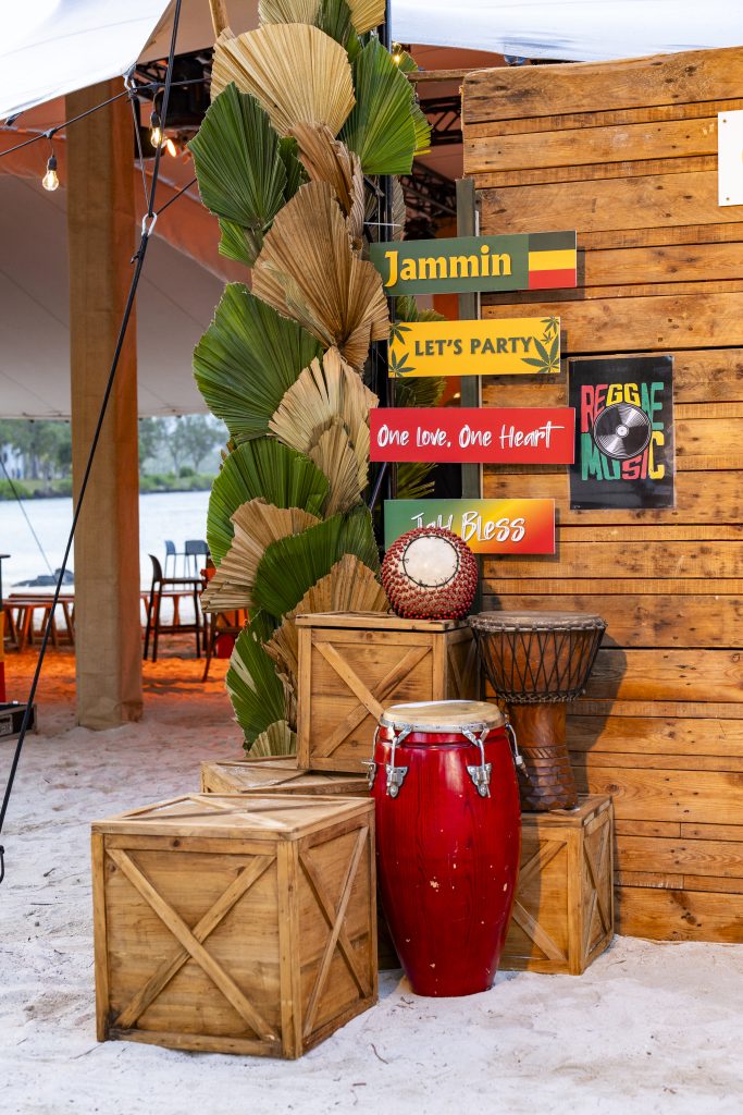Reggae Night Mauritius beach event with colourful décor, drum cocktail tables, pallet photo booth and immersive event styling by Impact Production Group
