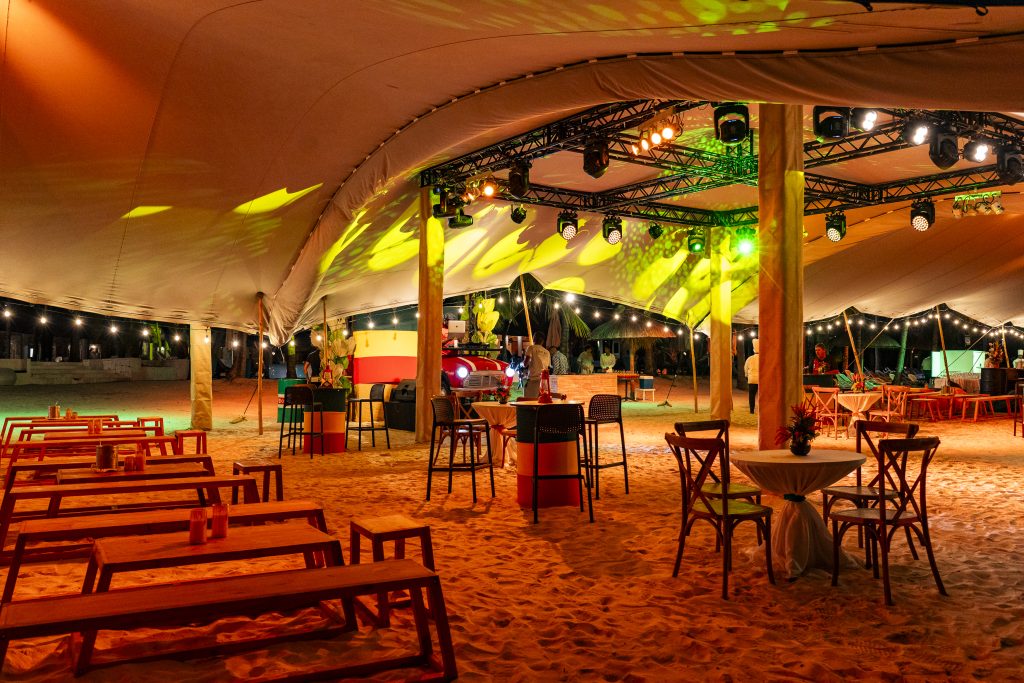 Reggae Night Mauritius beach event with colourful décor, drum cocktail tables, pallet photo booth and immersive event styling by Impact Production Group